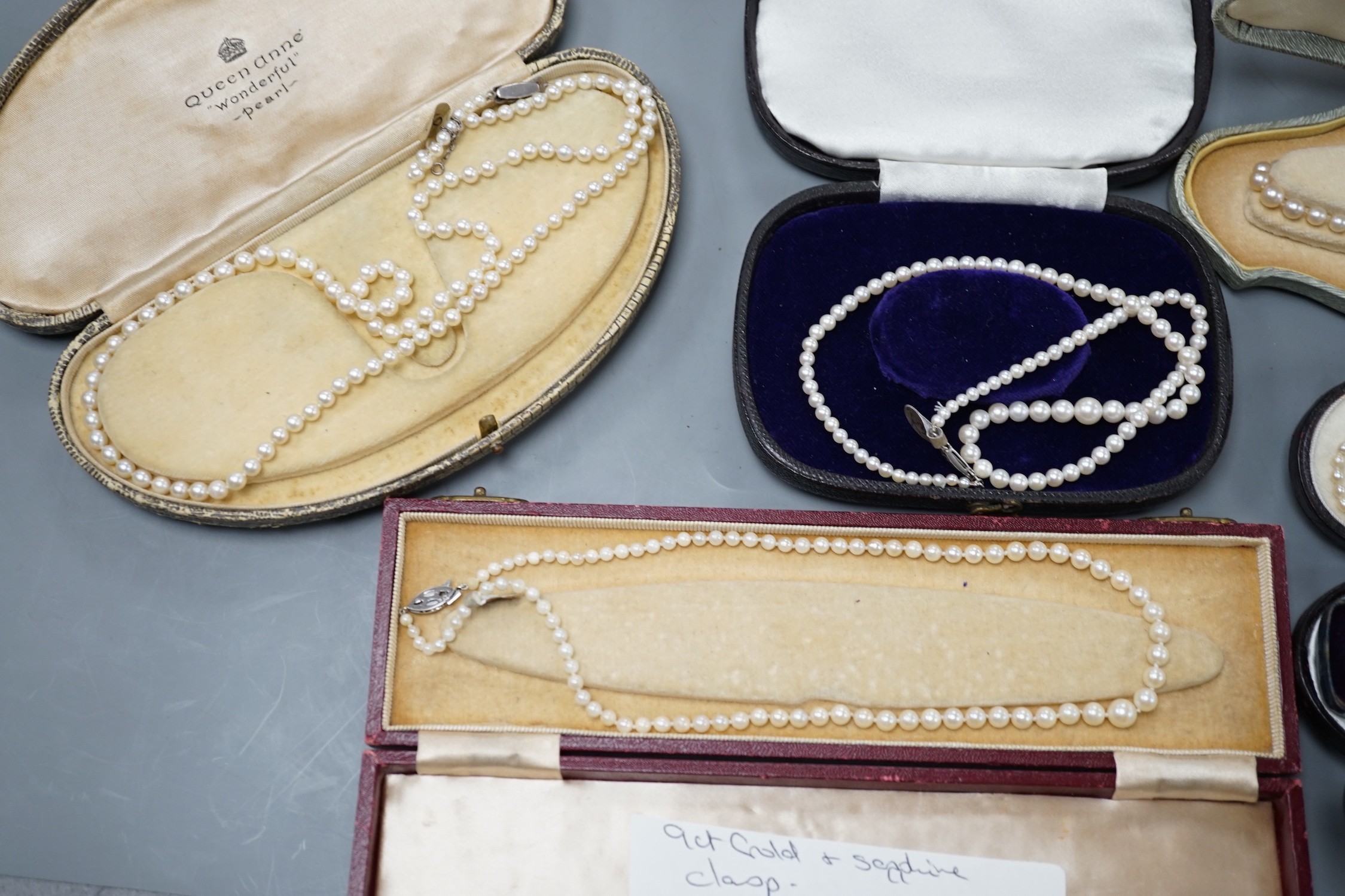 Six assorted single strand graduated cultured pearl necklaces, with marcasite or paste set clasps, longest 64cm and two small seed pearl necklaces, one with rose cut diamond and seed pearl set clasp.